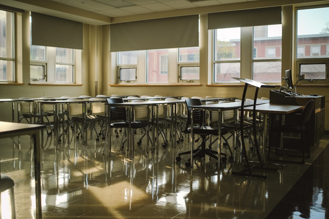 A classroom is empty, with sunlight reflecting.
