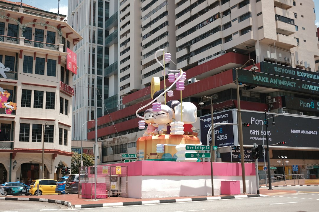 A colorful sculpture sits in front of buildings