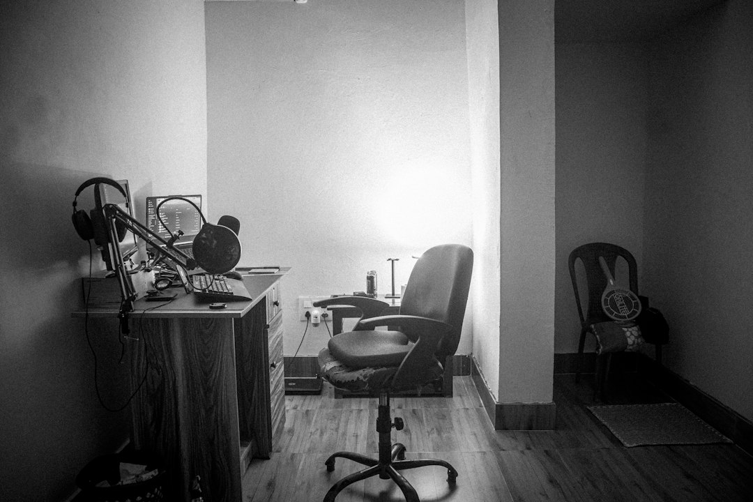 a room with a desk and chairs