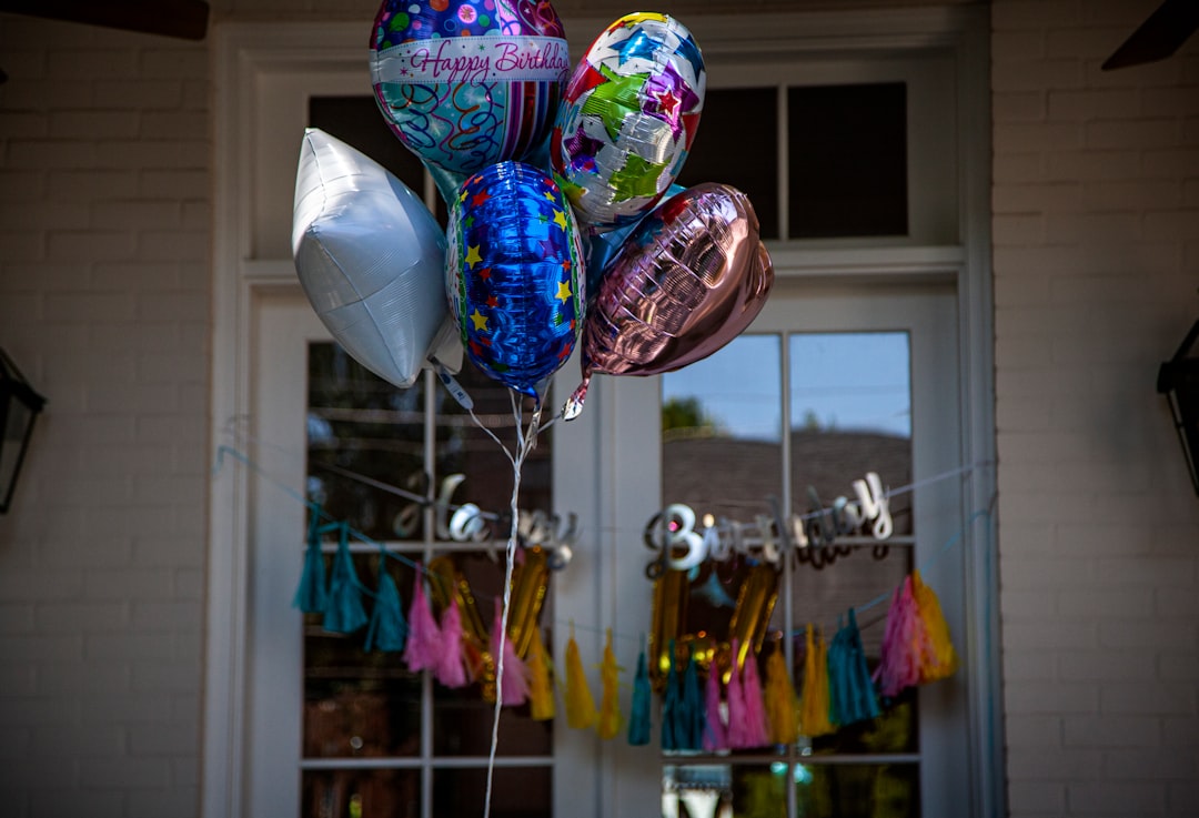 assorted color balloons hanged on string