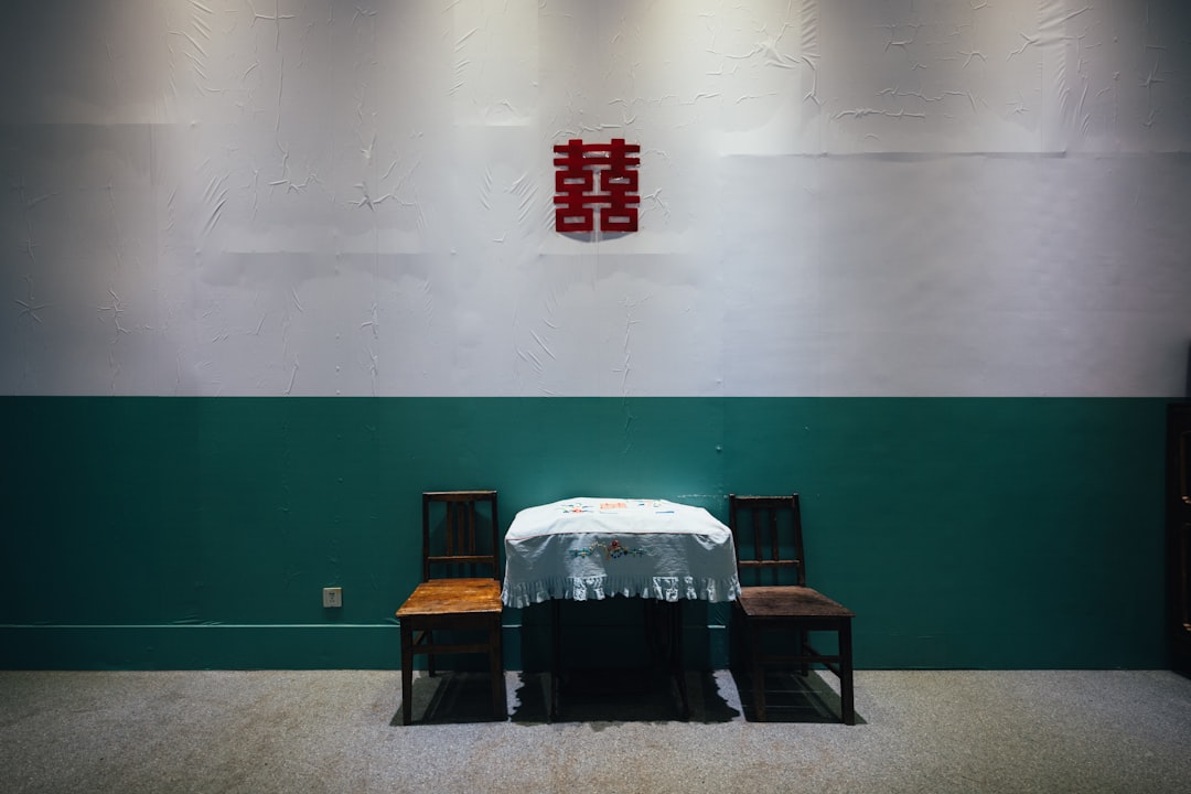 A table with two chairs and a red symbol