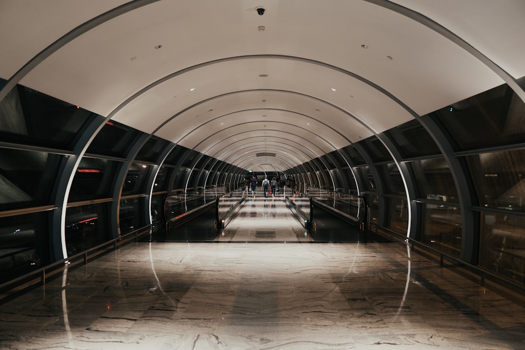 white and gray tunnel with glass walls