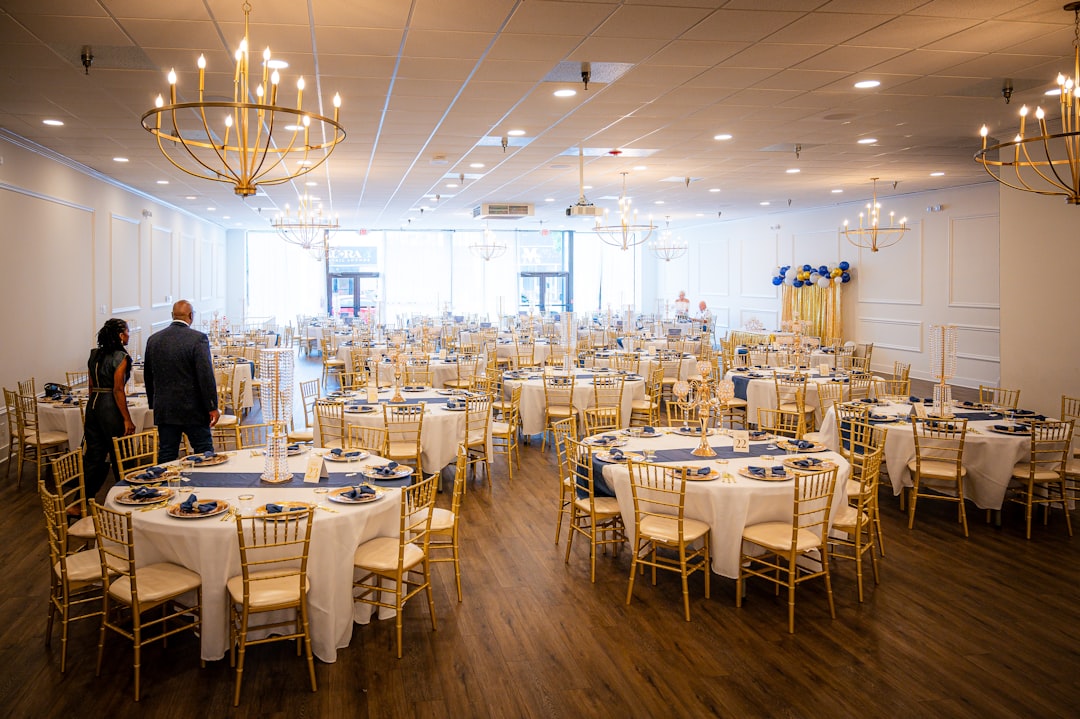 Elegant banquet hall set for an event with round tables.