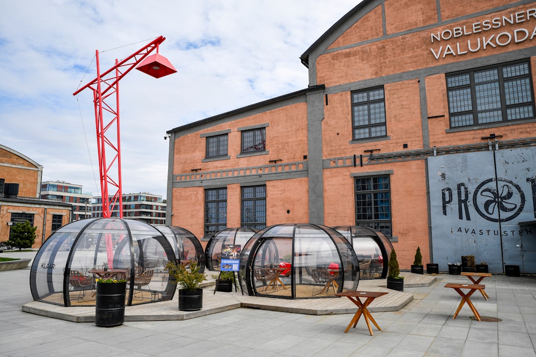 Outdoor dining igloos set up near brick buildings