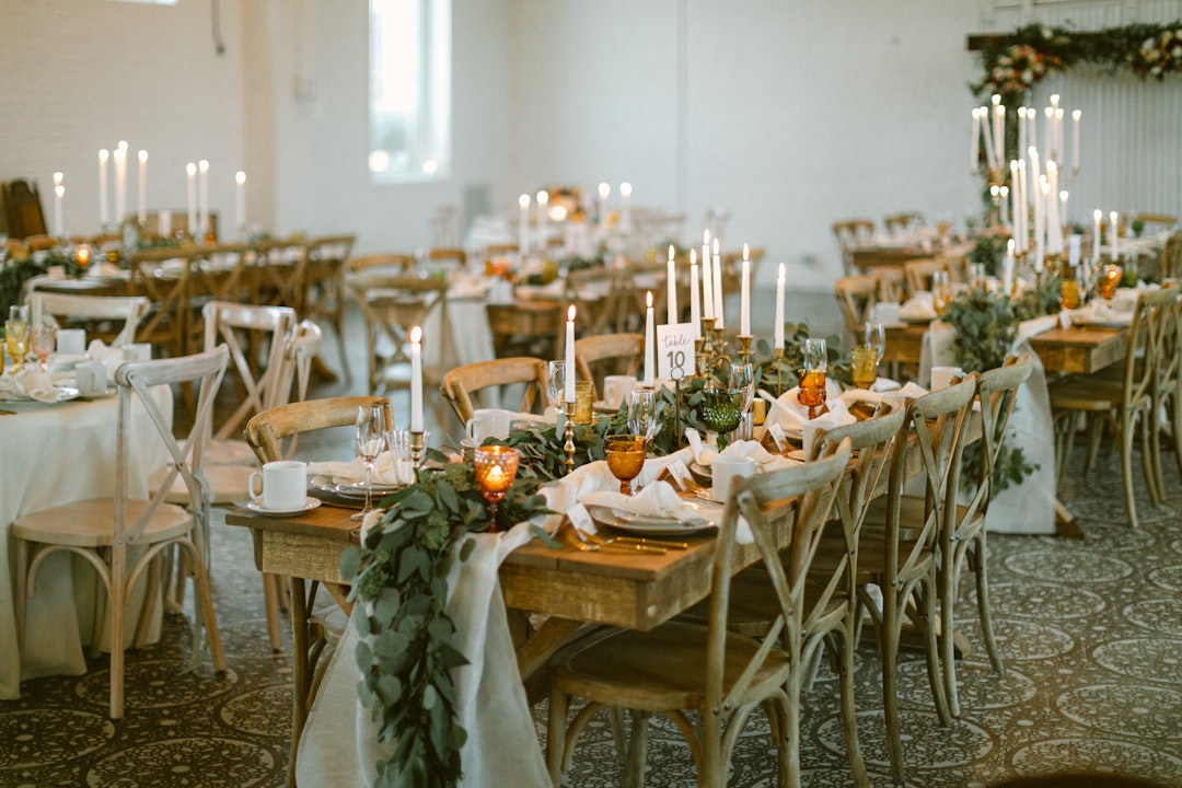 Wedding reception tables set with candles and greenery