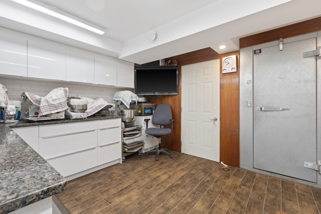 a room with a desk, chair and a television
